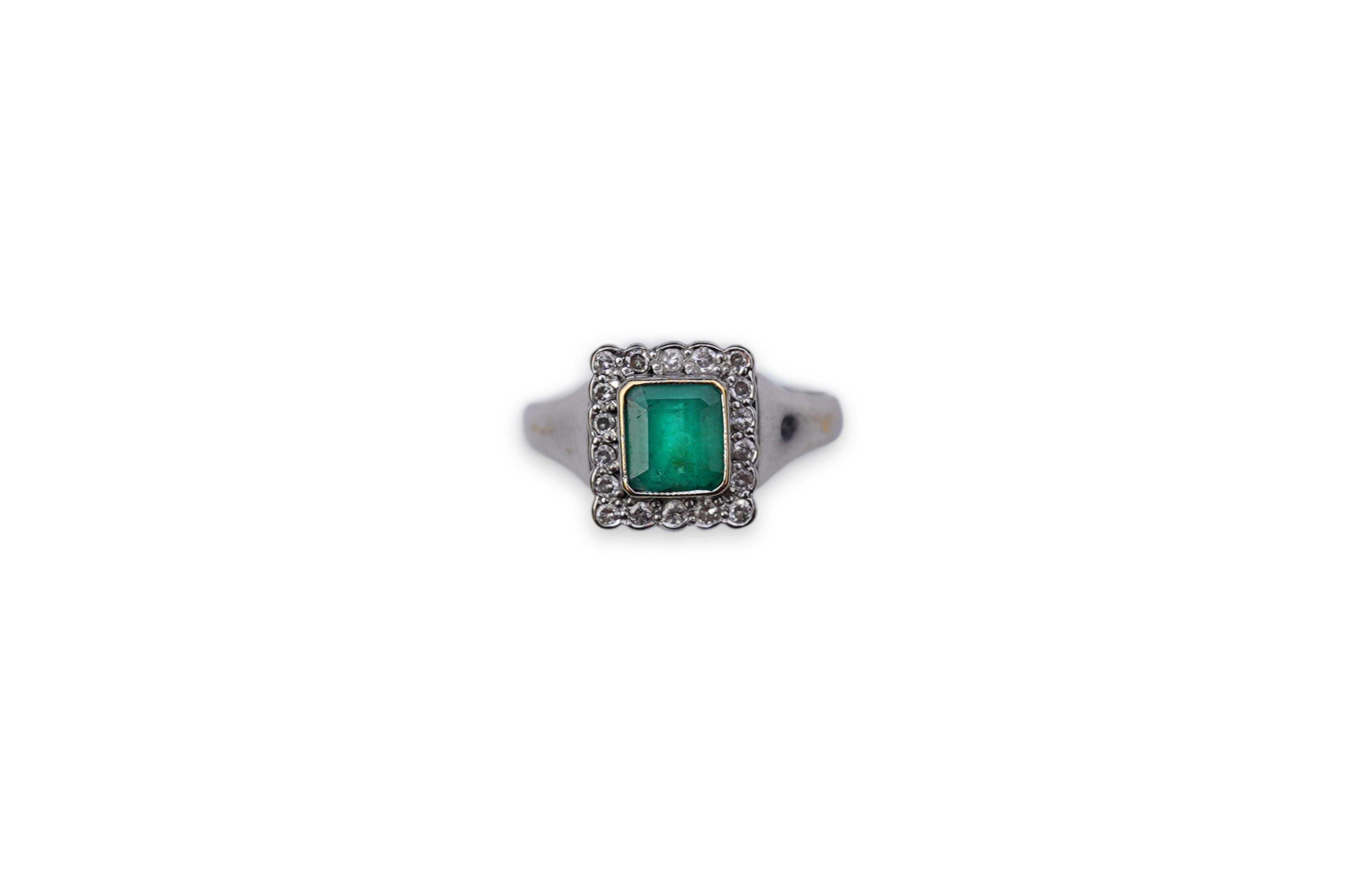 An emerald and diamond ring
